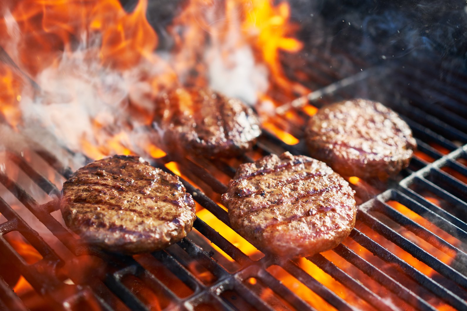 Cooking Burgers on Hot Grill with Flames